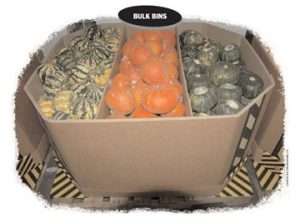 A box of oranges and other fruits on top of a table.